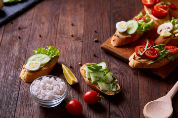 Breakfast sandwich with homemade paste, vegetables and fresh greens, shallow depth of field