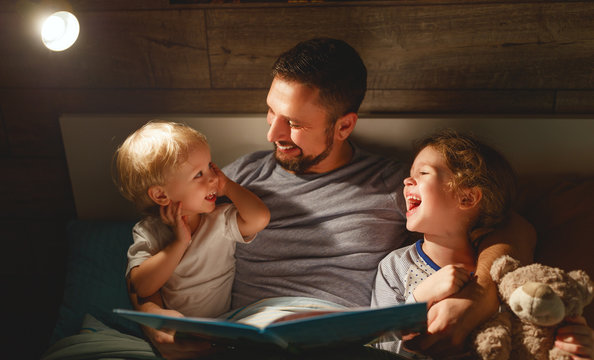 evening family reading. father reads children . book before going to bed