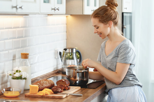 young woman in pajamas prepares breakfast in morning
