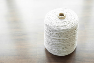 White packing rope on wooden background.