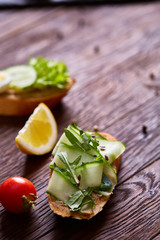 Breakfast sandwich with homemade paste, vegetables and fresh greens, shallow depth of field