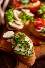 Breakfast sandwich with homemade paste, vegetables and fresh greens, shallow depth of field