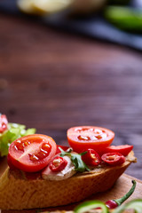 Breakfast sandwich with homemade paste, vegetables and fresh greens, shallow depth of field