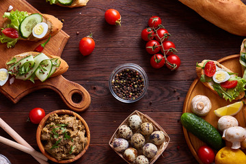 Breakfast still life with sandwiches, quail eggs, spicies and fresh fruits and vegetables, selective focus