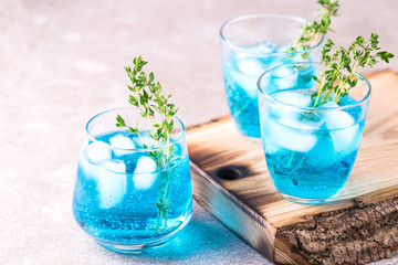 Ice Blue cocktail with thyme. Blue curacao liqueur. Summer