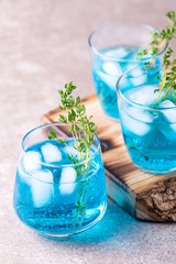 Ice Blue cocktail with thyme. Blue curacao liqueur. Summer