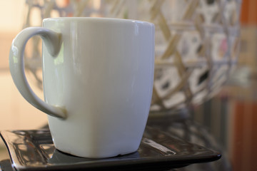 A cup of coffee on a glass table