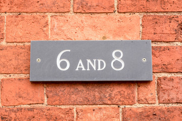 House number 6 and 8 sign on wall