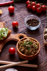 Paste from chicken liver with vegetables and quail eggs, shallow depth of field, close-up.