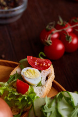 Breakfast sandwich with homemade paste, vegetables and fresh greens, shallow depth of field