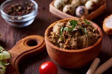 Paste from chicken liver with vegetables and quail eggs, shallow depth of field, close-up.