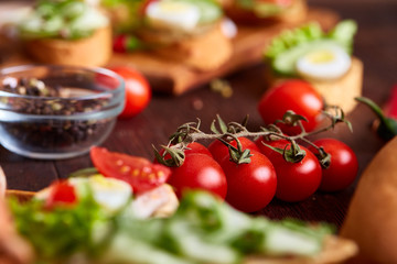 Breakfast still life with sandwiches, quail eggs, spicies and fresh fruits and vegetables, selective focus