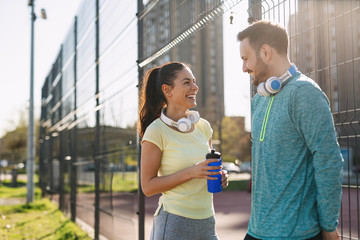 Portrait of man and woman during break of jogging