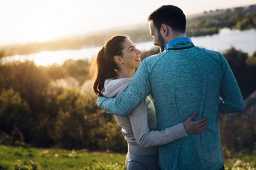 Happy young sporty couple sharing romantic moments