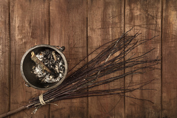 Overhead photo of witch's cauldron with broom and copy space