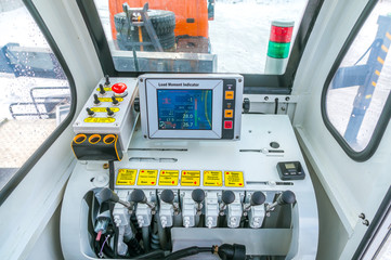 Crane control levers inside cabin. Digital load indicator.