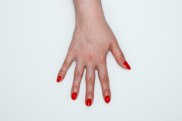Female palm with red nails painted on a white background - 200859702