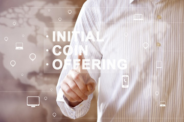 Businessman presses button ICO Initial Coin Offering on map virtual digital electronic user...