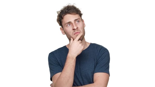 Portrait of brunette thoughtful guy in t-shirt thinking and choosing best option, isolated over white background. Concept of emotions