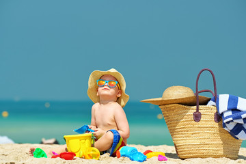 Two year old toddler playing on beach