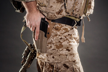 Soldier wearing uniform with gun in hand,keep gun in the holster. military concept