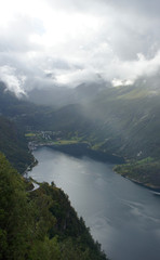 Fototapeta na wymiar Top view of the Geiranger fjord from the observation deck, sunrise, overcast, Norway