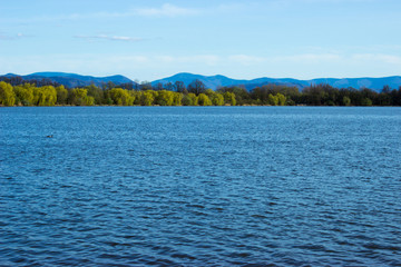 Blue water in lake - background mountains Beskydy