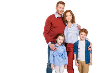 Fototapeta na wymiar happy red haired family with two kids standing together and smiling at camera isolated on white
