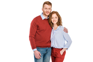 portrait of happy redhead couple standing together and smiling at camera isolated on white