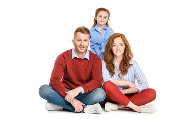 happy redhead family with one child smiling at camera isolated on white