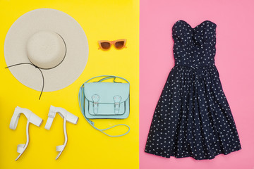 Fashionable concept. Female summer wardrobe. Straw hat, sundress, handbag and shoes. Yellow and pink