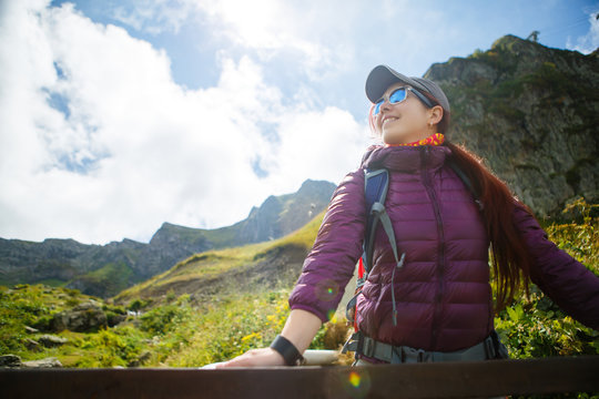 Image of woman in sunglasses against of mountains