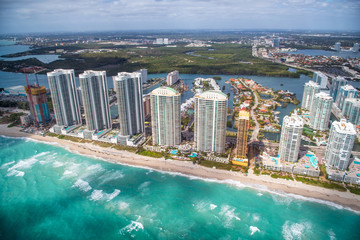 Aerial view of Miami Beach skyscrapers along the sea on a cloudy day