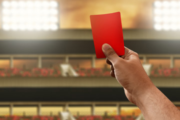 Soccer referee hand holding red card