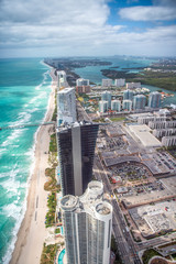 North Miami Beach as seen from helicopter. Skyscrapers along the ocean, aerial view - obrazy, fototapety, plakaty