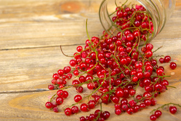 currants on wooden table background, spilled from a spice jar. .Antioxidants, detox diet, organic fruits. Berries