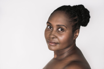 Fototapeta na wymiar Young African woman with beautiful skin against a white background
