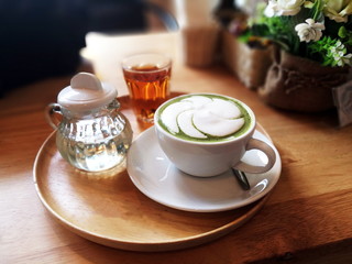Matcha green tea latte on wood background