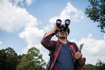  Young  with Binocular onwith outdoor forest on background  Travel concept.