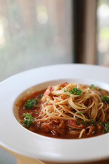 spaghetti Bolognese with minced beef and tomato sauce garnished with parmesan cheese and basil , Italian food