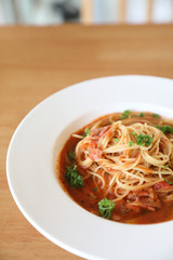spaghetti Bolognese with minced beef and tomato sauce garnished with parmesan cheese and basil , Italian food