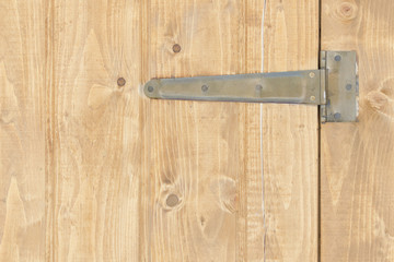 Fototapeta premium Part of the brown wooden door with hinges