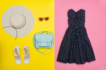 Fashionable concept. Female summer wardrobe. Straw hat, sundress, handbag and shoes. Yellow and pink
