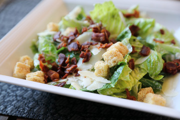 Caesar salad , vegetable with bread bacon and cheese