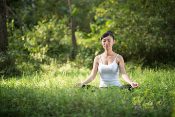 Naklejka na ściany i meble woman playing yoga garden field weekend holiday lifestyle park outdoor nature background.