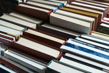 Many books in a bookstore or library on wooden background with copy space