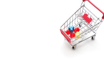 Miniature house and shopping cart on white background : economy concept