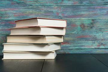 Stack books on wooden background. Back to school with copy space.