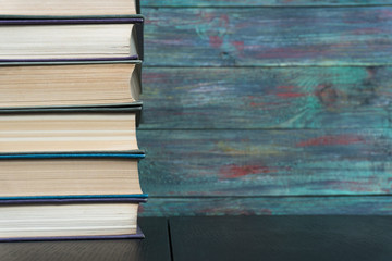 Stack books on wooden background. Back to school with copy space.