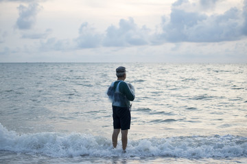 The fisherman stood anticipation by the sea in the morning, at sunrise, Songkhla province, Thailand country